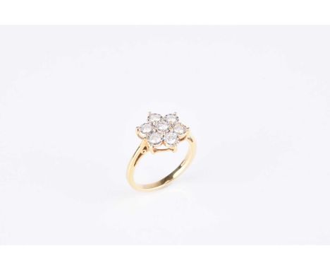 An 18ct gold brilliant cut diamond floral cluster ring, the diamonds claw set in white gold to yellow gold shank, ring size M