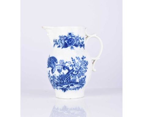 A small Caughley 'Parrot Pecking Fruit' maskhead cabbage leaf jug, circa 1780-85, transfer-printed in underglaze blue, painte