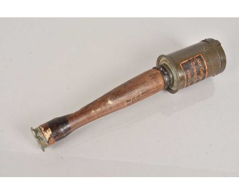 An inert WWI German Practice Stick Grenade, having cannister to the top, with attached label and stamp to the wooden handle, 