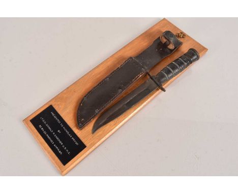 A US Presentation Dagger by US Utica Cut Co, mounted on board with plaque, 'Presented to Nicholas Pryor by Lt Col Donald R Ga