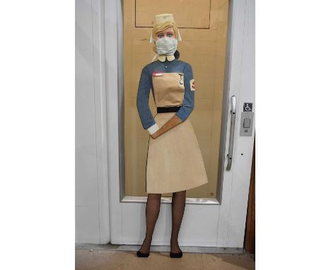 A Life Size plywood model of a Naval Nurse, having a vacuum pack plastic face/head, ideal for a vintage display, in two piece