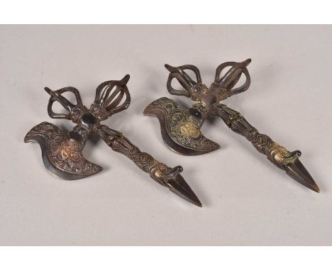 A pair of Tibetan Ritual Axes, the cast metal axe having remnants of red paint and heightened in gilt, both approximately 22c