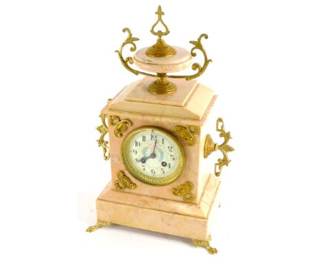 A French late 19thC pink marble mantel clock, with gilt metal mounts, the top with an urn finial above an enamel dial painted