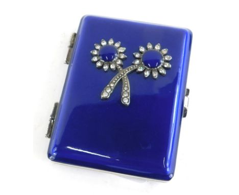 An early 20thC blue enamel and silver plated compact, with paste stone set double flower decoration to front, the interior se