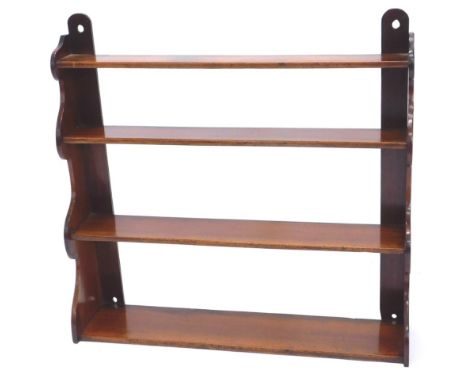 A Victorian mahogany graduated wall shelf, on shaped end supports, 84cm wide.