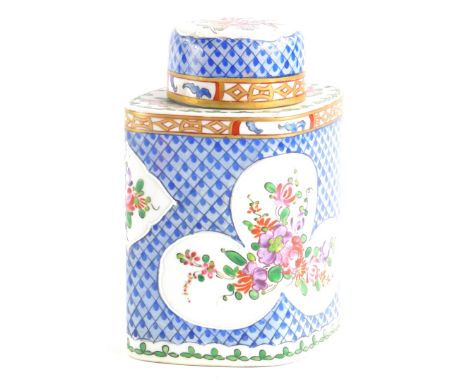 A continental porcelain lozenge shaped tea caddy and cover, decorated in oriental style with flowers, leaves, within a stylis