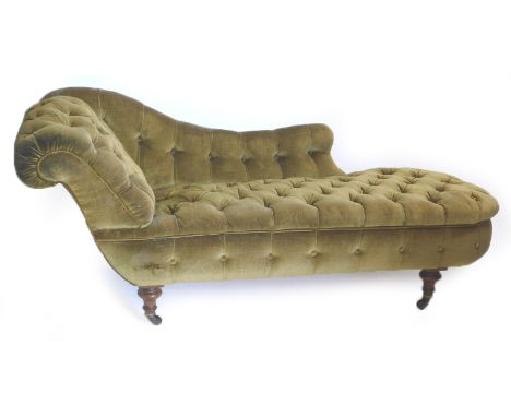 A Victorian walnut chaise lounge, upholstered in buttoned green fabric, on turned legs with ceramic castors, 176cm long.