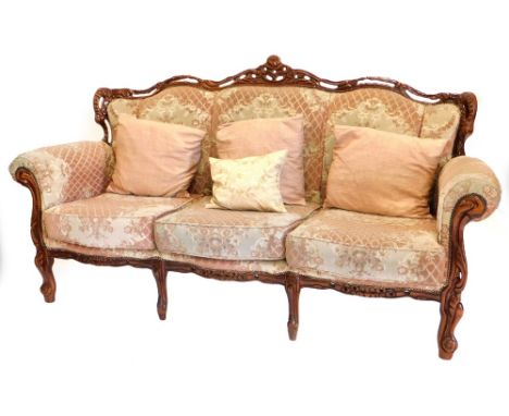 A continental beech three seater sofa, in the French style, upholstered in pink, cream and grey fabric, on cabriole legs, tog