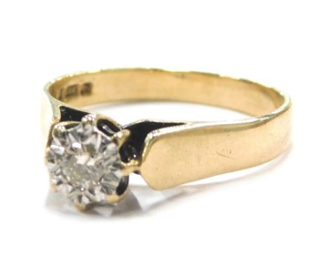 A 9ct gold solitaire ring, set with imitation tiny diamond, in a white gold setting, raised shoulders with open work centre, 