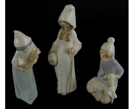 A collection of three Lladro figures, to include a young girl with a walking stick, a child with a cockerel and another with 