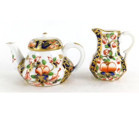 A 19thC Stevenson and Hancock Derby porcelain Imari pattern miniature teapot, and a small jug. (2)