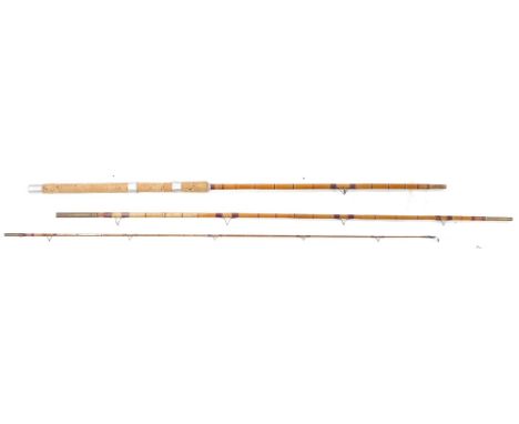 A vintage cane three piece fishing rod, with brass mounts and cork handle.