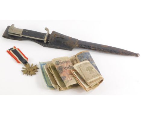 A German bayonet, the blade stamped Rich.Abr.Herber Solingen, with leather scabbard, a Third Reich 1939 merit award medal and