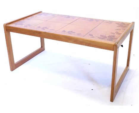 A teak rectangular coffee table, with a brown glaze tile top, 84cm wide.