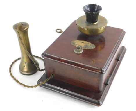 An early 20thC vintage telephone, with brass and black Bakelite mouth piece, brass handset and mahogany casing, indistinct la