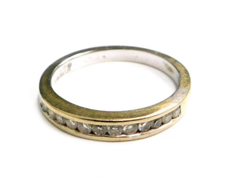 An 18ct white gold half hoop eternity ring, set with tiny diamonds in tension setting, ring size M½, 3.3g all in. 