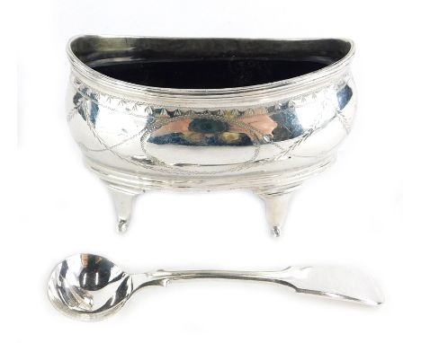 A George III silver salt, of oval form with reeded edges and bright cut pendant husk decoration, on four peg feet, with a lat