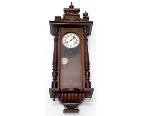 A late 19thC Vienna type wall clock, in a walnut case with a white enamel dial flanked by part reeded pilasters, 93cm high. (
