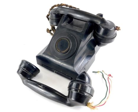 An incomplete vintage black Bakelite telephone, stamped to underside 4509B, (AF), and an extra black Bakelite handset.