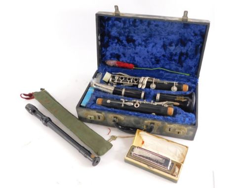 A Boosey and Hawkes clarinet, in a fitted case, a Coch Chromatic harmonica and a Schotts C Descant recorder.  (3)