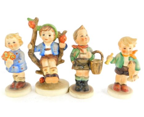 Four various Goebel Hummel design figurines, to include boy sitting on a branch, boy with basket, etc.