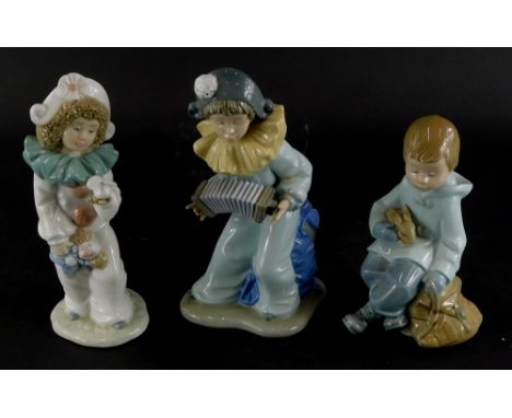 Two similar Nao Pierrot porcelain figures, modelled in the form of a child playing an instrument and with a clown doll, and t