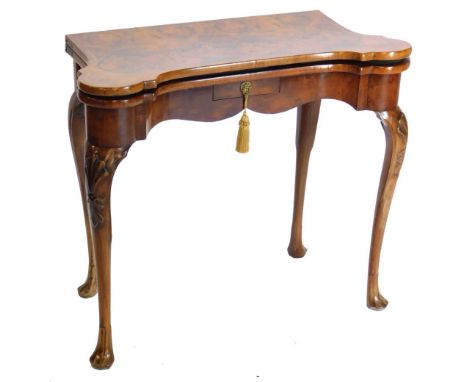 A mid 18thC walnut card table, the figured top with feather banded border and rounded corners, enclosing a baize lined interi