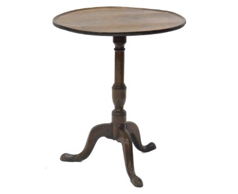 An early 19thC oak occasional table, the circular dished tilt top on a turned column and tripod base, with pad feet, 57cm dia