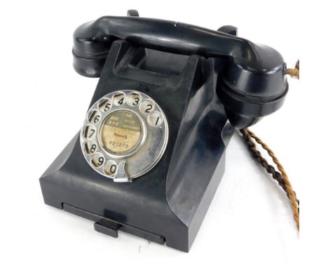 A vintage black Bakelite telephone, number to underside 4509B. (AF)