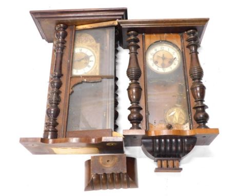Two late 19th/early 20thC walnut Vienna type wall clocks, each with enamel decoration to the dial, part turned pilasters, etc