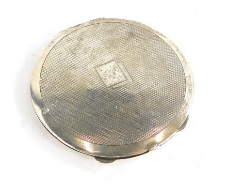 An Edward VIII silver powder compact, with engine turned decoration and vacant cartouche, the interior with a mirror and spac