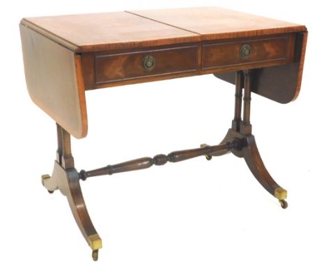 A mahogany and satinwood crossbanded sofa table, the rectangular top with rounded corners above two frieze drawers opposing f