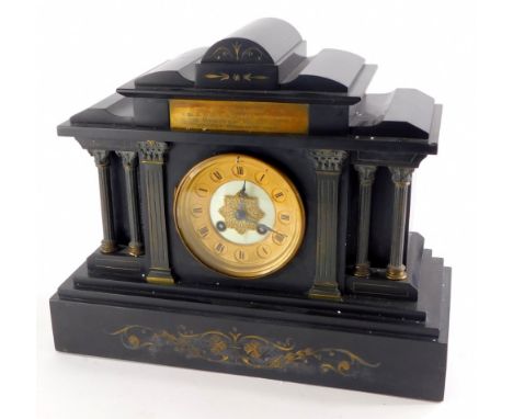 A late 19thC/early 20thC French black slate portico shaped mantel clock, with reeded Corinthian columns, etc. and scroll desi