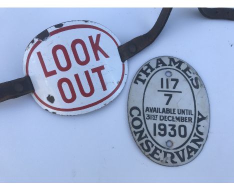 An enamel 'Look Out' oval armband with straps for attaching to the arm and a 1930 Thames Conservancy Boat License oval enamel