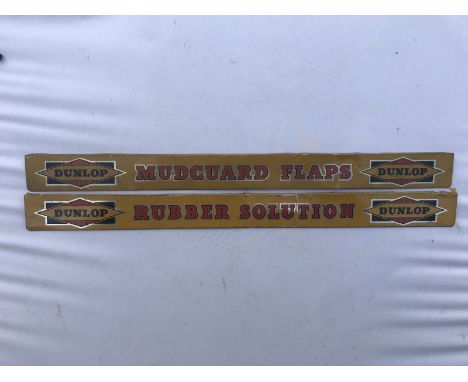A pair of Dunlop shelf strips advertising 'mudguard flaps' and 'rubber solution'. 