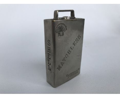 A rare Shell branded lighter with match striker to the base, in the shape of an oil can. 