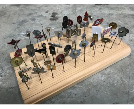 A collection of approximately 55 stick pins relating to petrol and oil products.