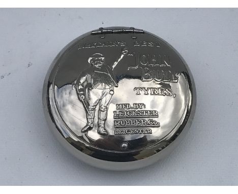 A John Bull Tyres circular snuff box with an embossed lid, in good condition.