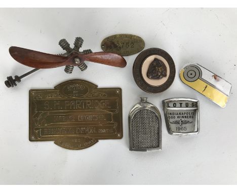 A small box of motoring collectables to include a miniature Bentley 3 litre radiator, a mahogany two blade propeller from a d