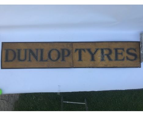 A Dunlop Tyres two piece tin advertising sign, 59 1/2 x 11 1/2".