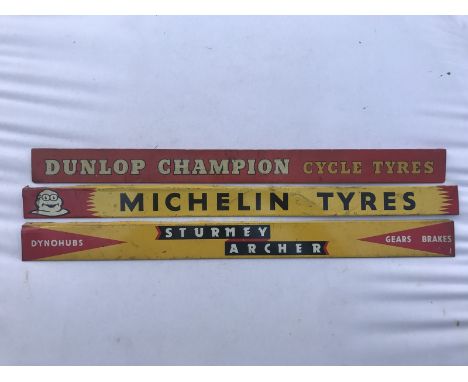 A Dunlop Champion Cycle Tyres shelf strip, another for Michelin Tyres and a third advertising Sturmey Archer. 