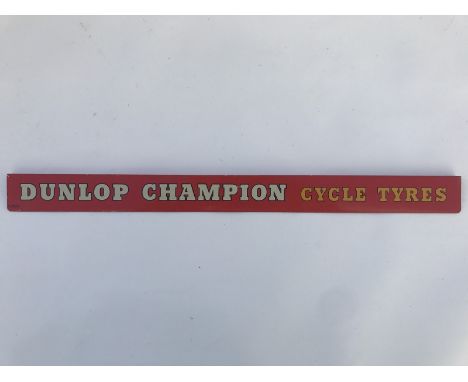 A Dunlop Champion Cycle Tyres shelf strip, in good condition. 
