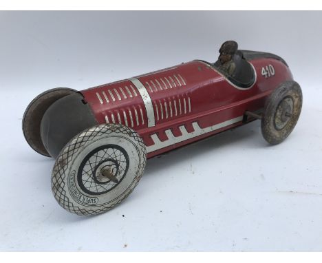 A clockwork tinplate single seater racing car by Marx.