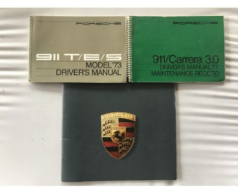 A Porsche 911T/E/S model 1973 driver's manual, another driver's manual for the 911/Carrera 3.0 1977 and a Porsche brochure ci