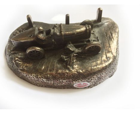 A bronzed sculpture by K. Mason, depicting a Bugatti, 25/50.