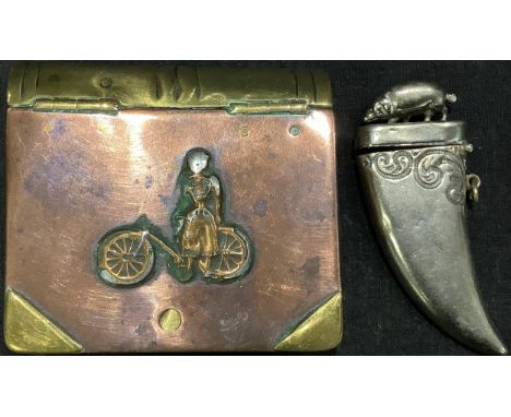 A copper and brass 'trench art' table snuff box modelled as a book, applied with a cyclist; a boar tusk vesta (2) 