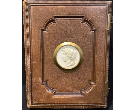 A Victorian tooled leather photograpgh album, the cover applied with a cameo portrait plaque, c.1880 