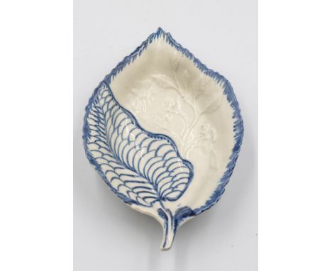 A Liverpool  blue and white leaf shaped dish moulded with a trailing branch and butterflyCirca 1780Length 13cm, width 8.5cm  
