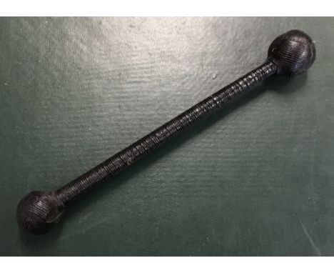 A late 19th / early 20th century double ended cosh. Of unusual form, with a weighted ball terminal to both ends. Blackened wo