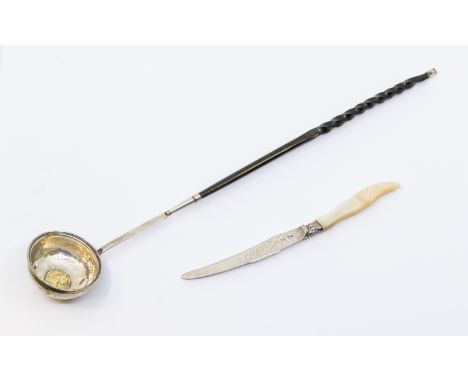 An 18th Century white metal toddy ladle, baleen twist handle and gilt Queen Anne silver shilling to centre of bowl, dated 171